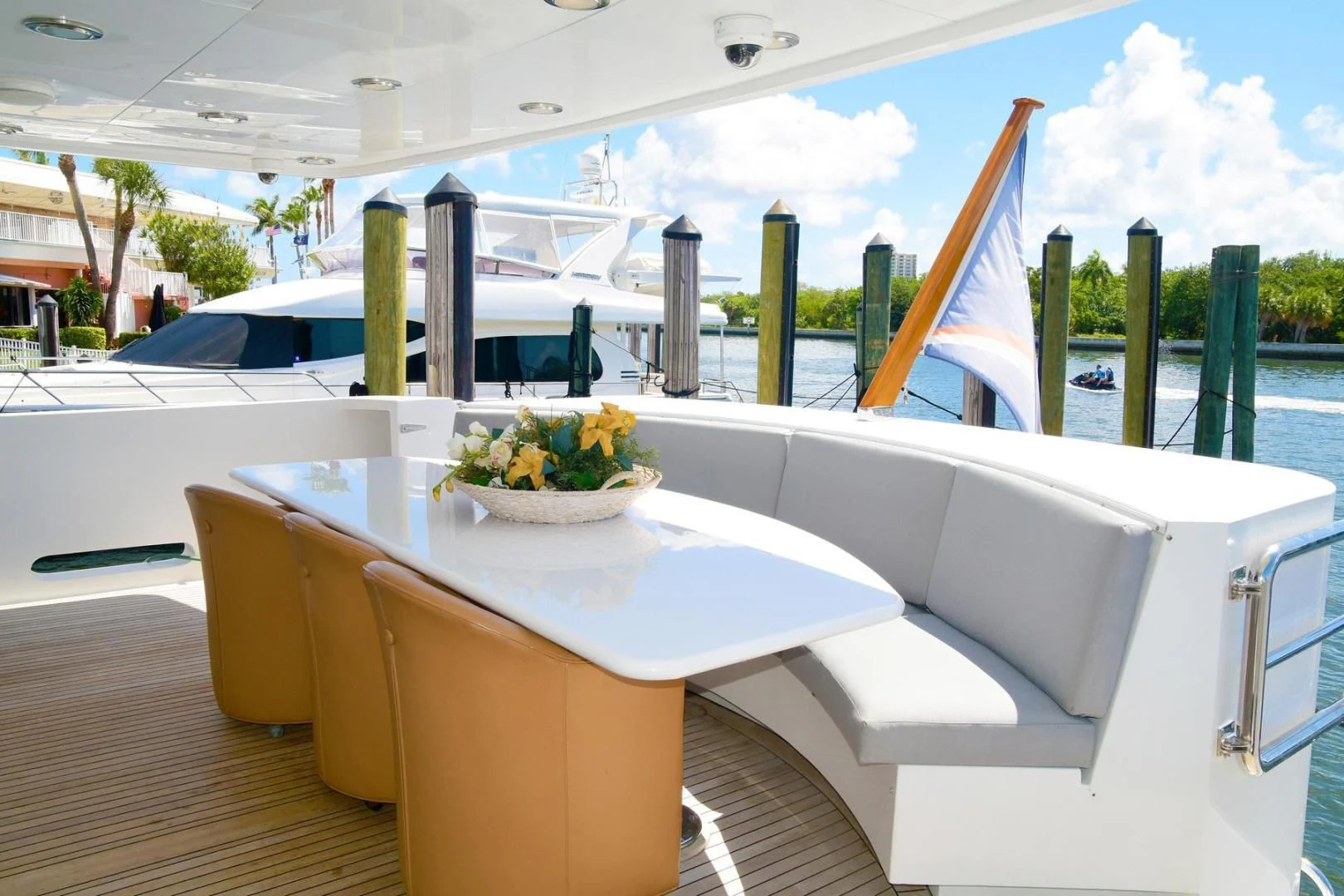 a table with chairs and a bowl of salad on it aboard CARPE DIEM Yacht for Charter