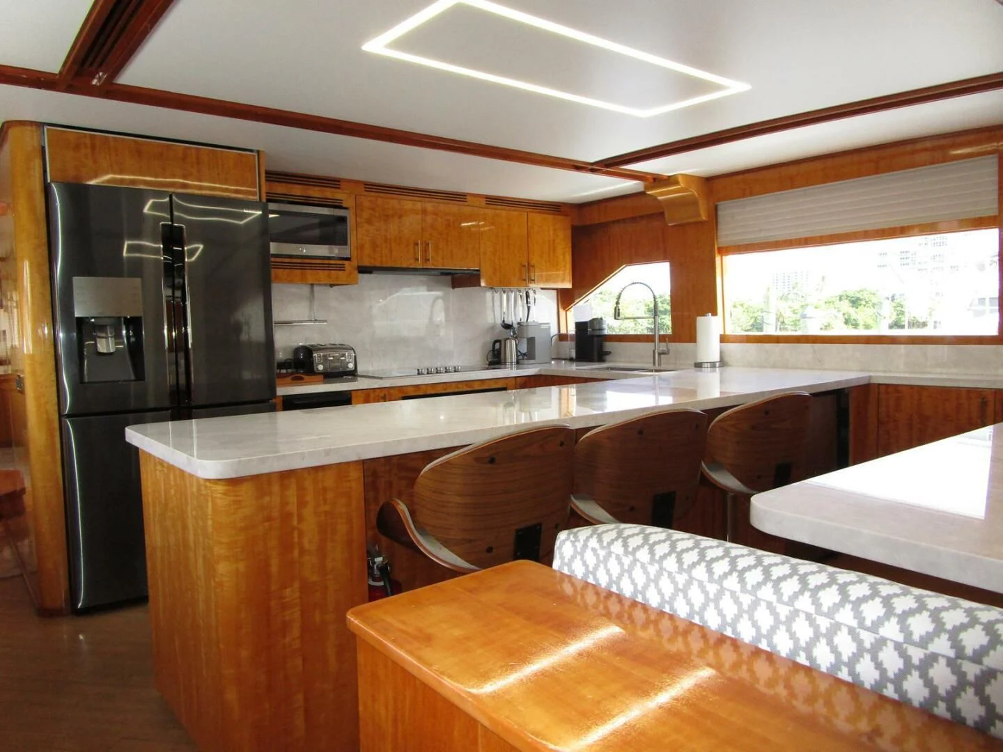 a kitchen with a refrigerator and a table aboard CARPE DIEM Yacht for Charter