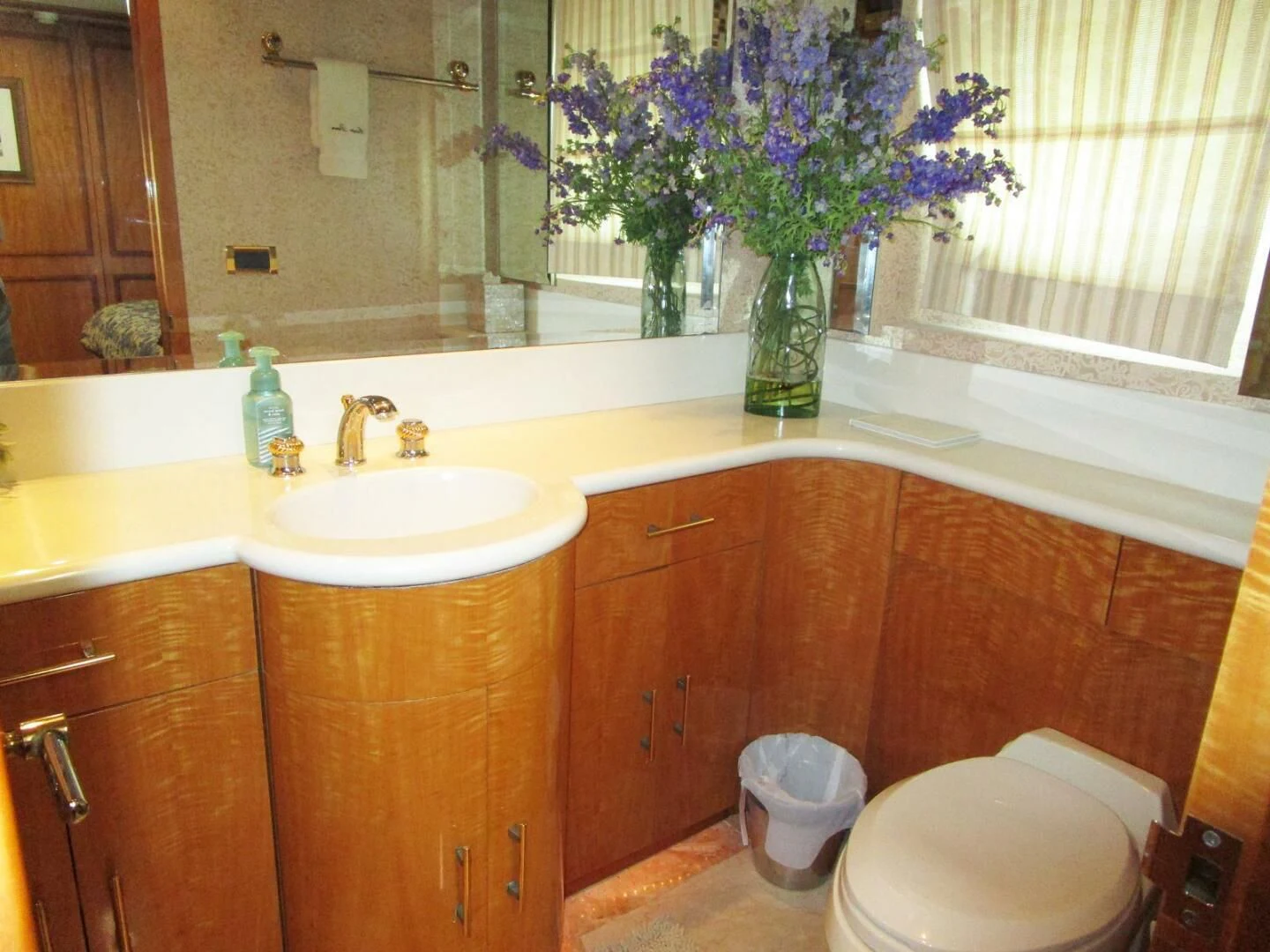 a bathroom with a vase of flowers aboard CARPE DIEM Yacht for Charter