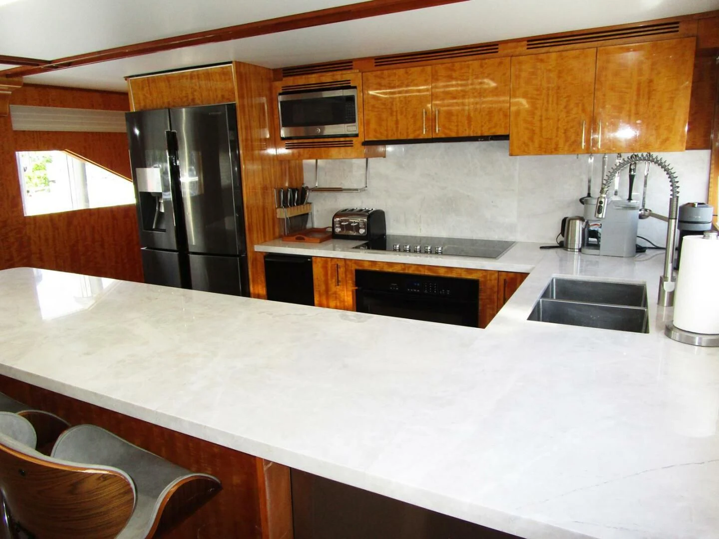a kitchen with wooden cabinets aboard CARPE DIEM Yacht for Charter