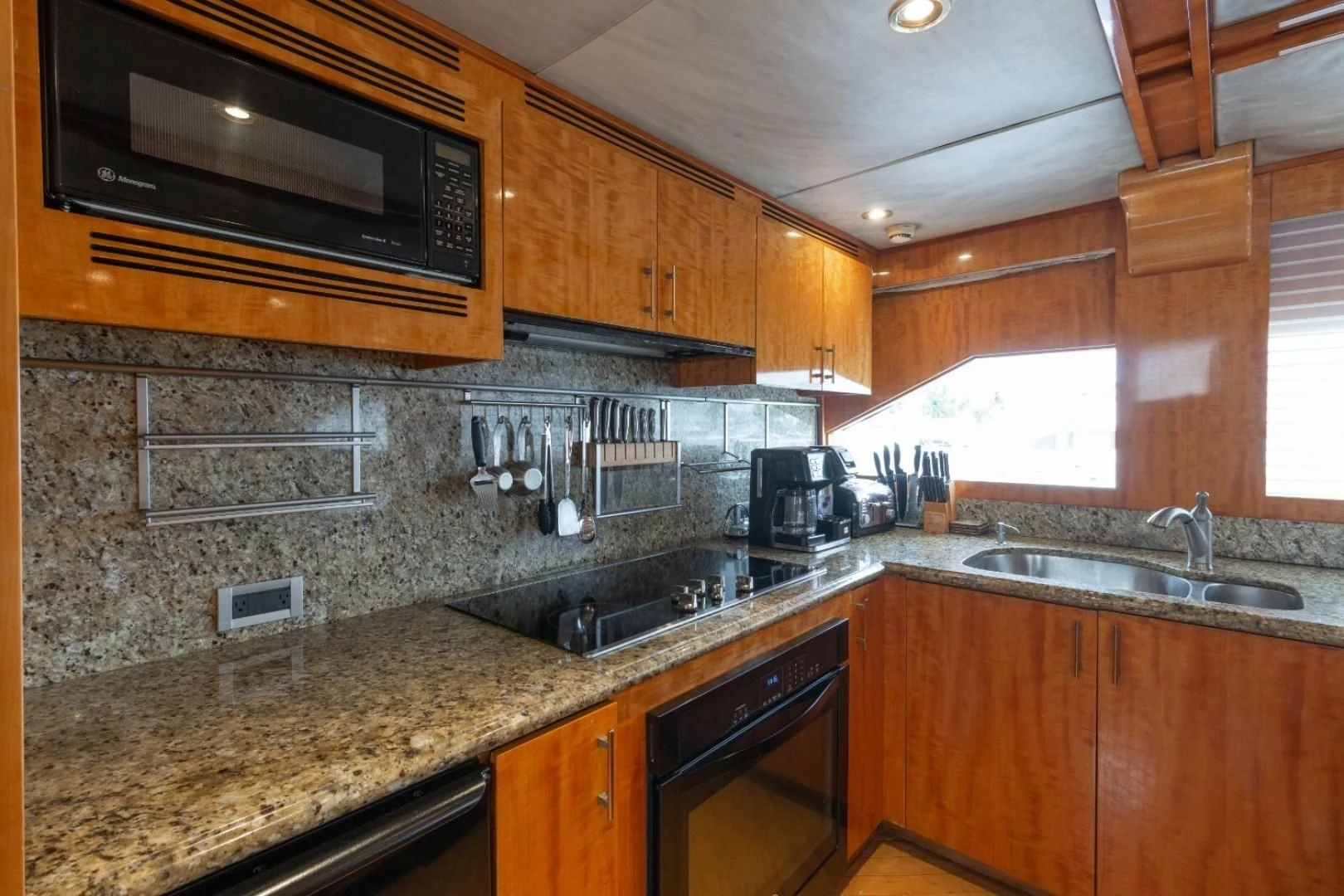 a kitchen with wooden cabinets aboard CARPE DIEM Yacht for Charter