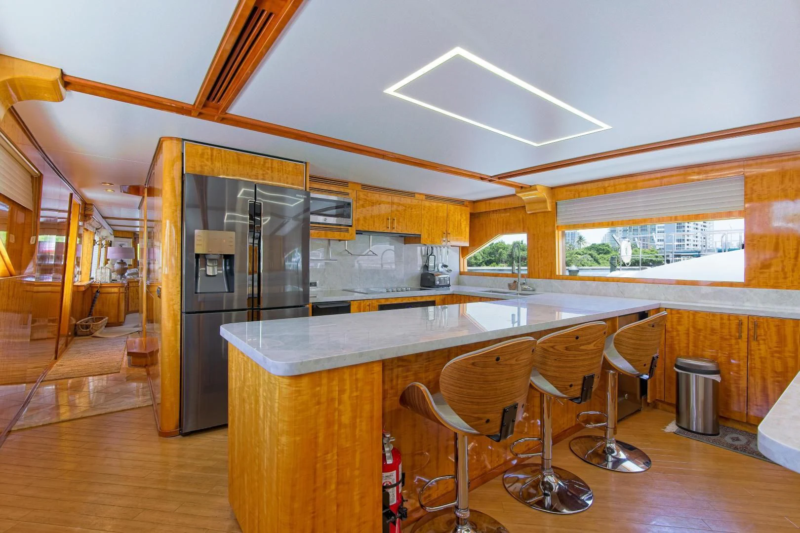 a kitchen with a bar and refrigerator aboard CARPE DIEM Yacht for Charter