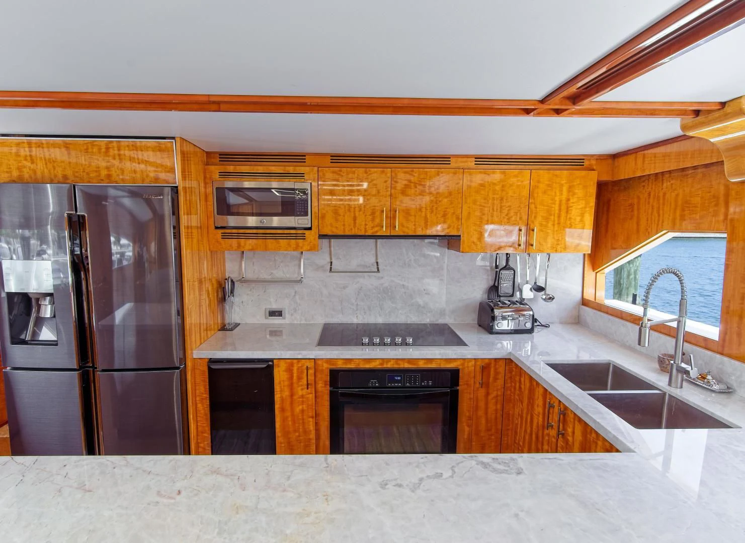 a kitchen with black appliances aboard CARPE DIEM Yacht for Charter