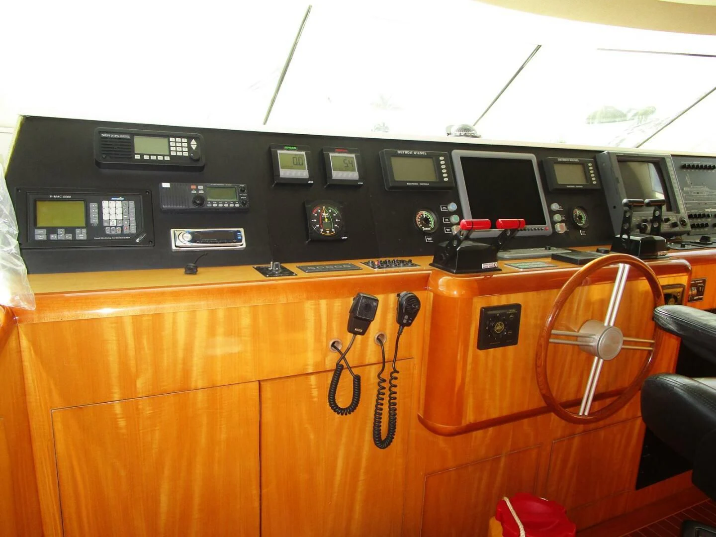 a wooden desk with several electronic devices aboard CARPE DIEM Yacht for Charter