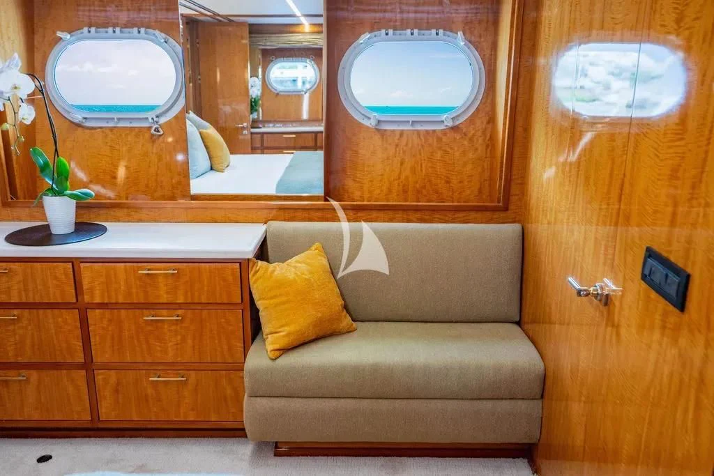 a living room with a couch and a window aboard CARPE DIEM Yacht for Charter