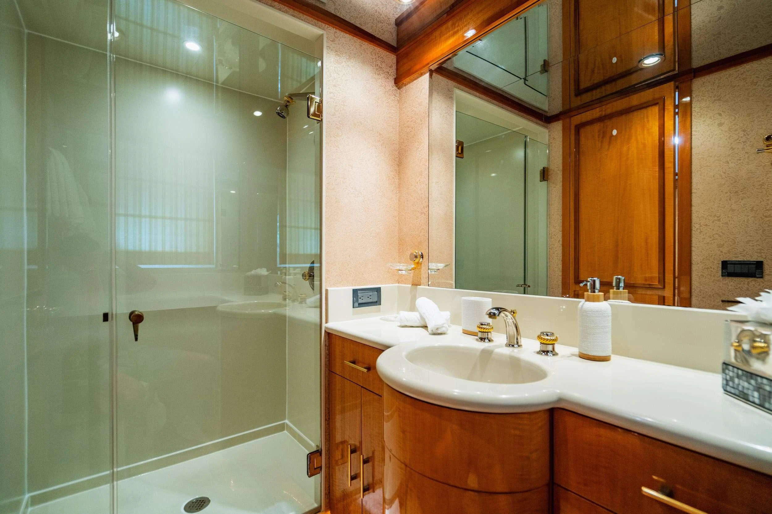 a bathroom with a glass shower aboard CARPE DIEM Yacht for Charter