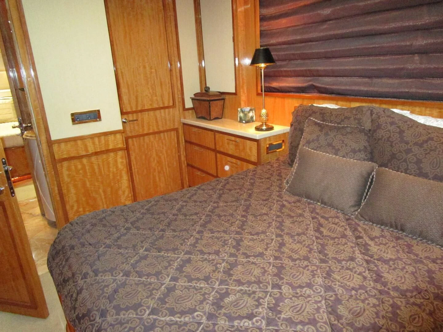 a bed with a blue comforter aboard CARPE DIEM Yacht for Charter
