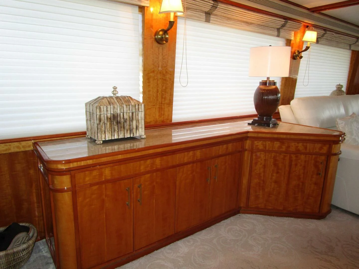 a room with a dresser and a lamp aboard CARPE DIEM Yacht for Charter
