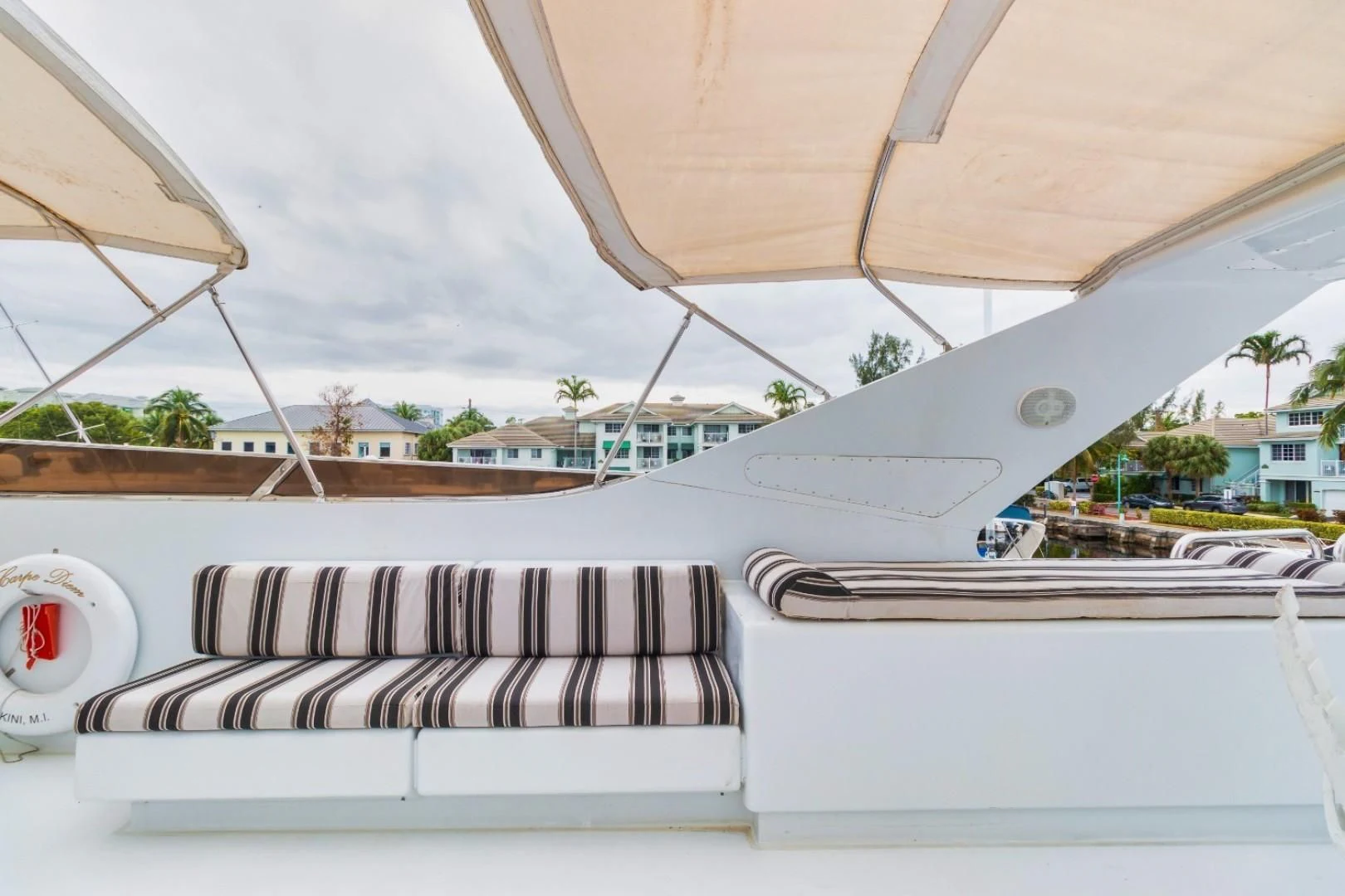 a white boat with a red logo aboard CARPE DIEM Yacht for Charter