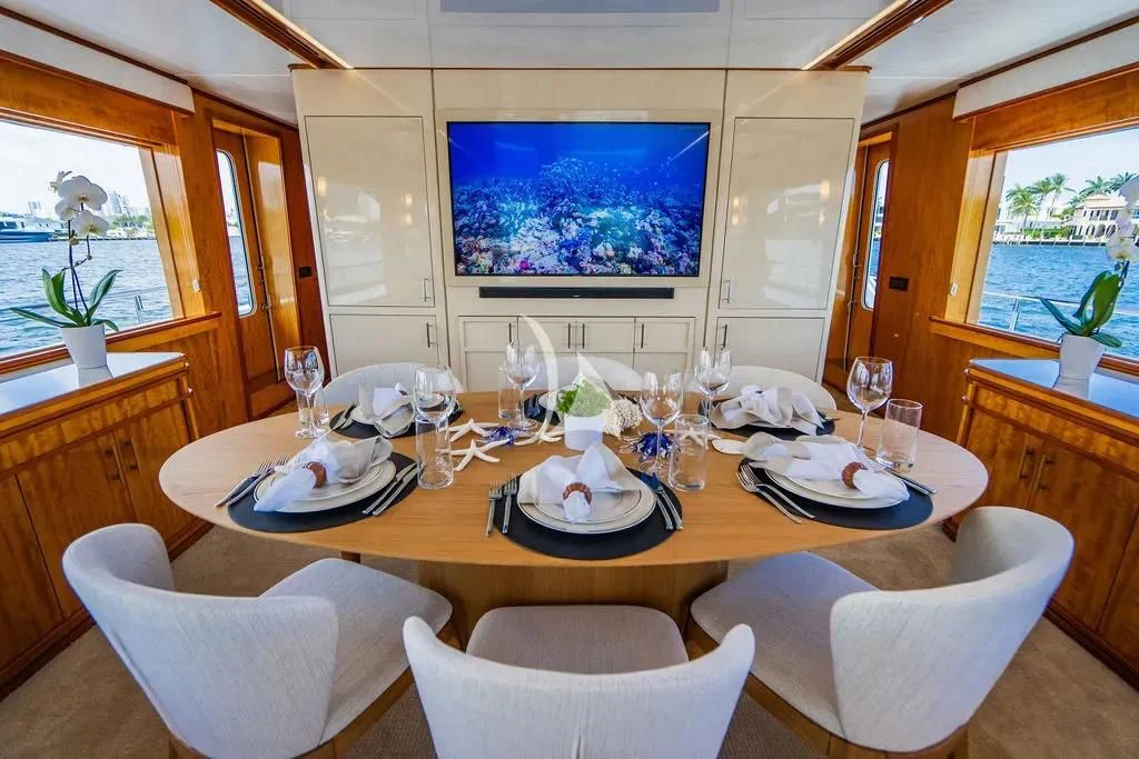 a dining table with plates and glasses aboard CARPE DIEM Yacht for Charter