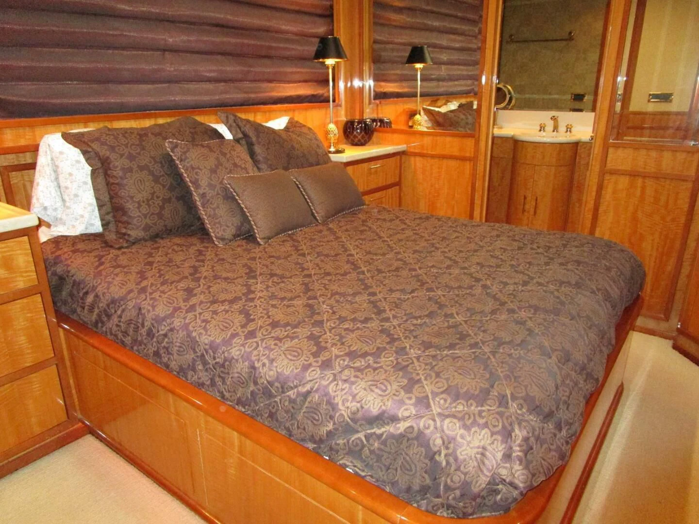 a bed with a blue comforter aboard CARPE DIEM Yacht for Charter