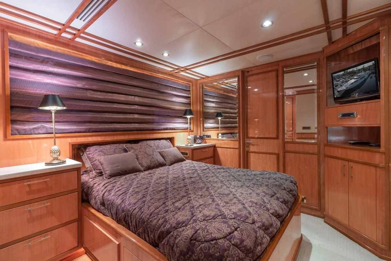 a bedroom with a bed and a television aboard CARPE DIEM Yacht for Charter