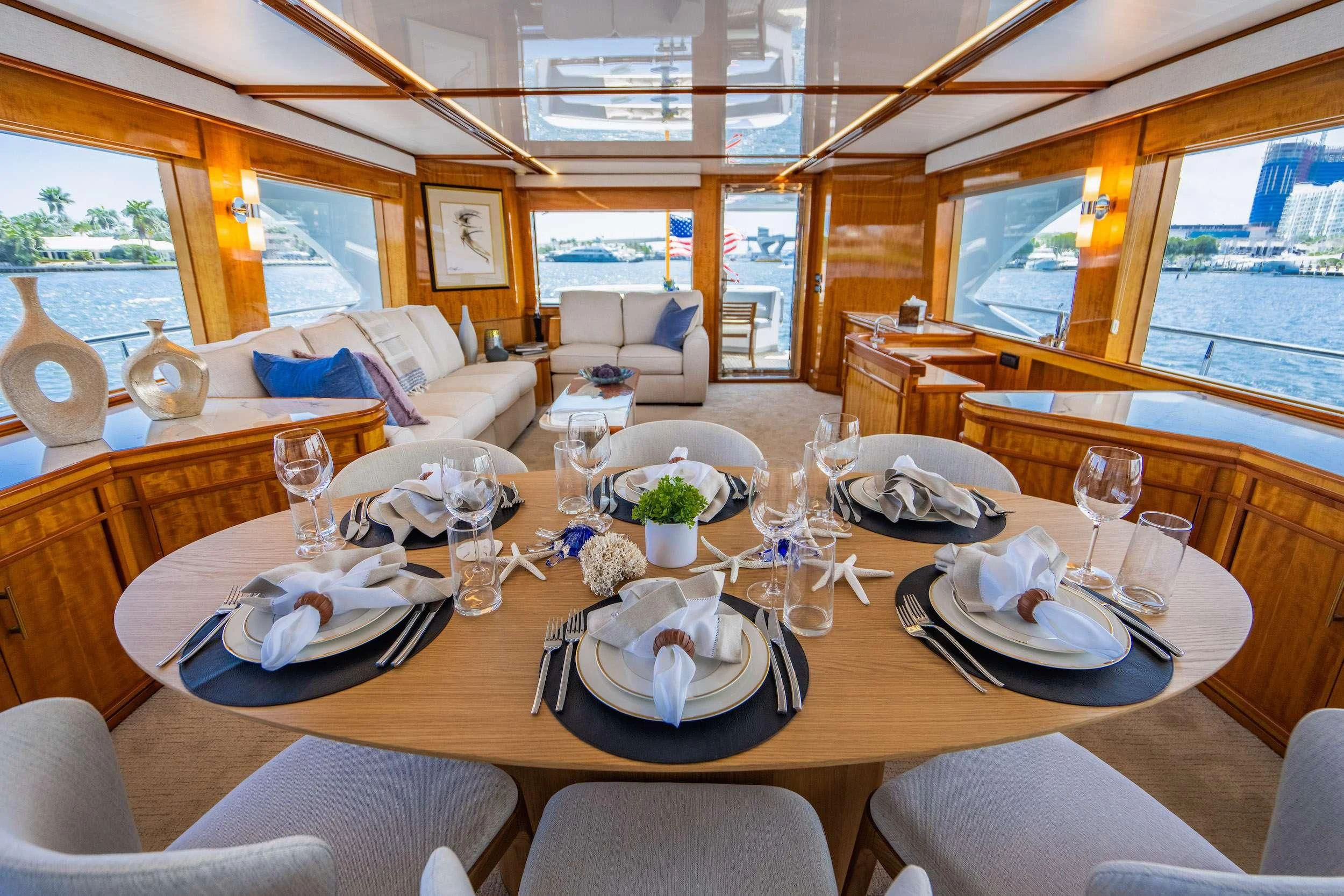 a large dining table with plates and glasses on it aboard CARPE DIEM Yacht for Charter