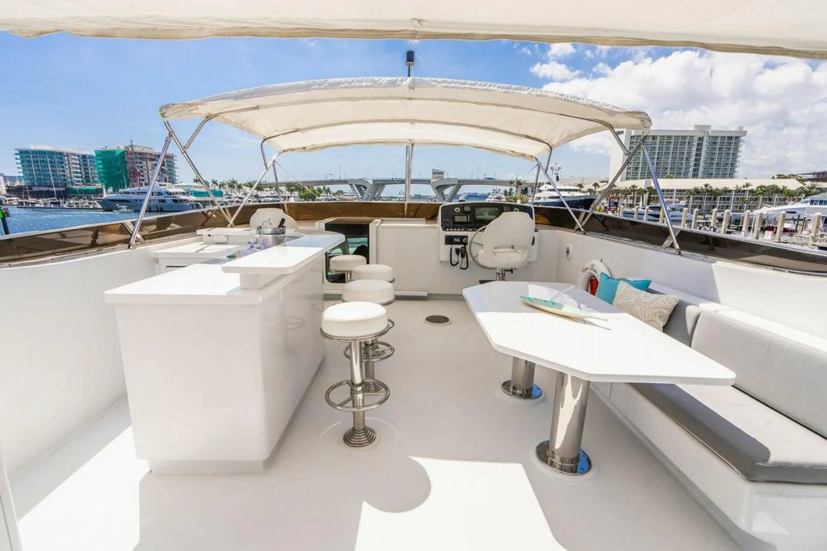 a white table with white tables and chairs on it aboard CARPE DIEM Yacht for Charter
