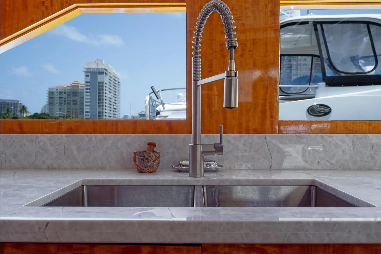 a kitchen sink with a window aboard CARPE DIEM Yacht for Charter