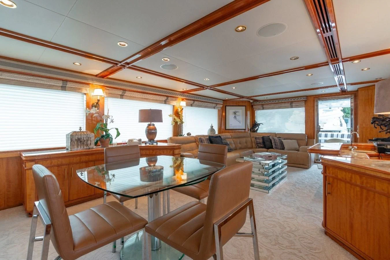 a large living room with a large wood table and chairs aboard CARPE DIEM Yacht for Charter