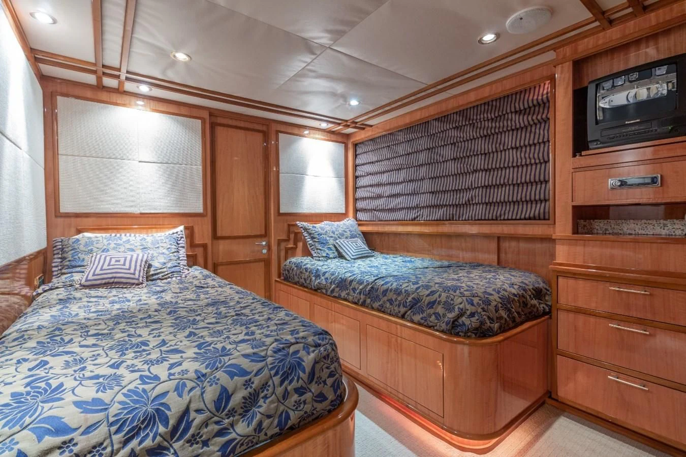 a bedroom with a bed and a television aboard CARPE DIEM Yacht for Charter