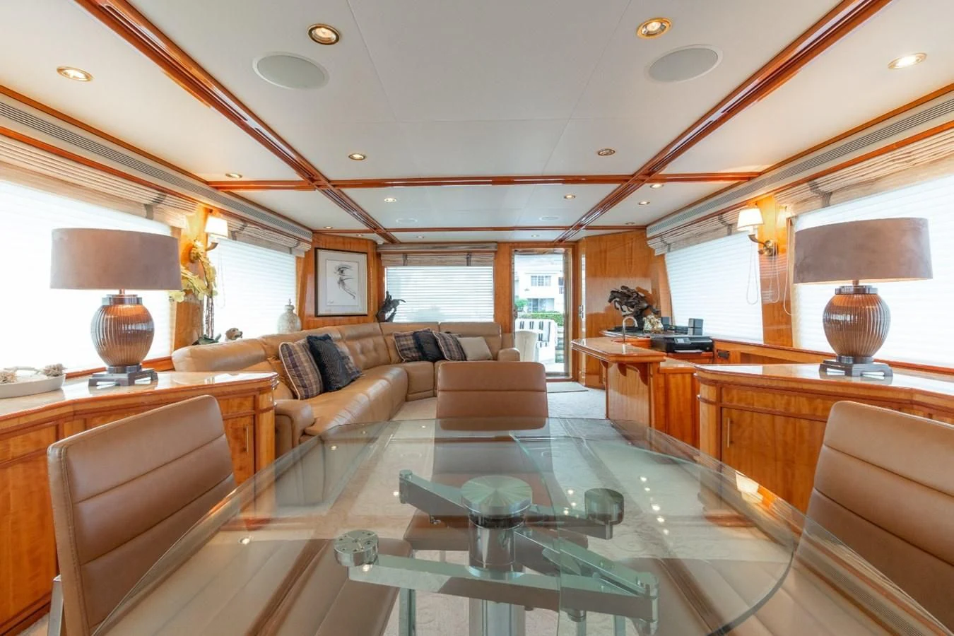 a living room with a large glass table and a large window aboard CARPE DIEM Yacht for Charter