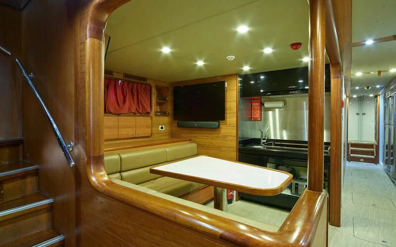 a room with a table and tv aboard ALAIA Yacht for Sale