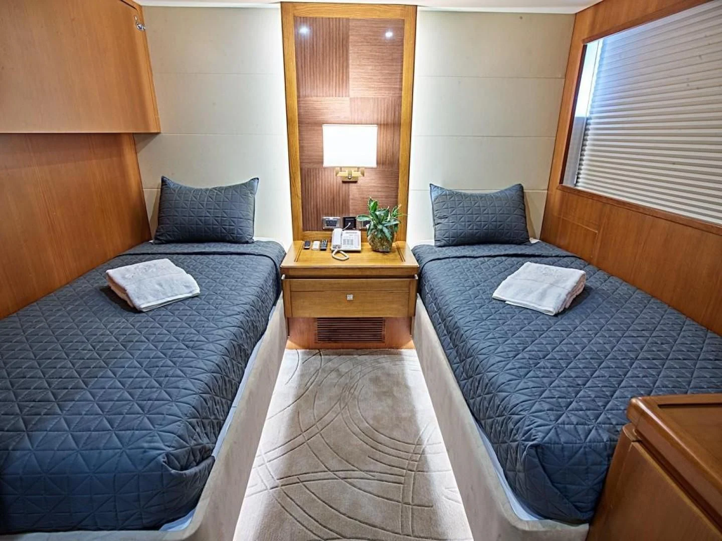 a hotel room with a bed and a lamp aboard ALAIA Yacht for Sale