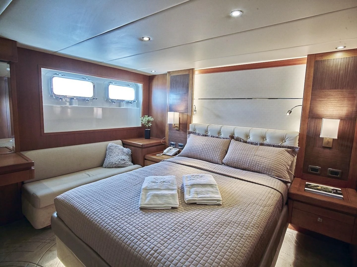 a bed with a white bed spread aboard ALAIA Yacht for Sale