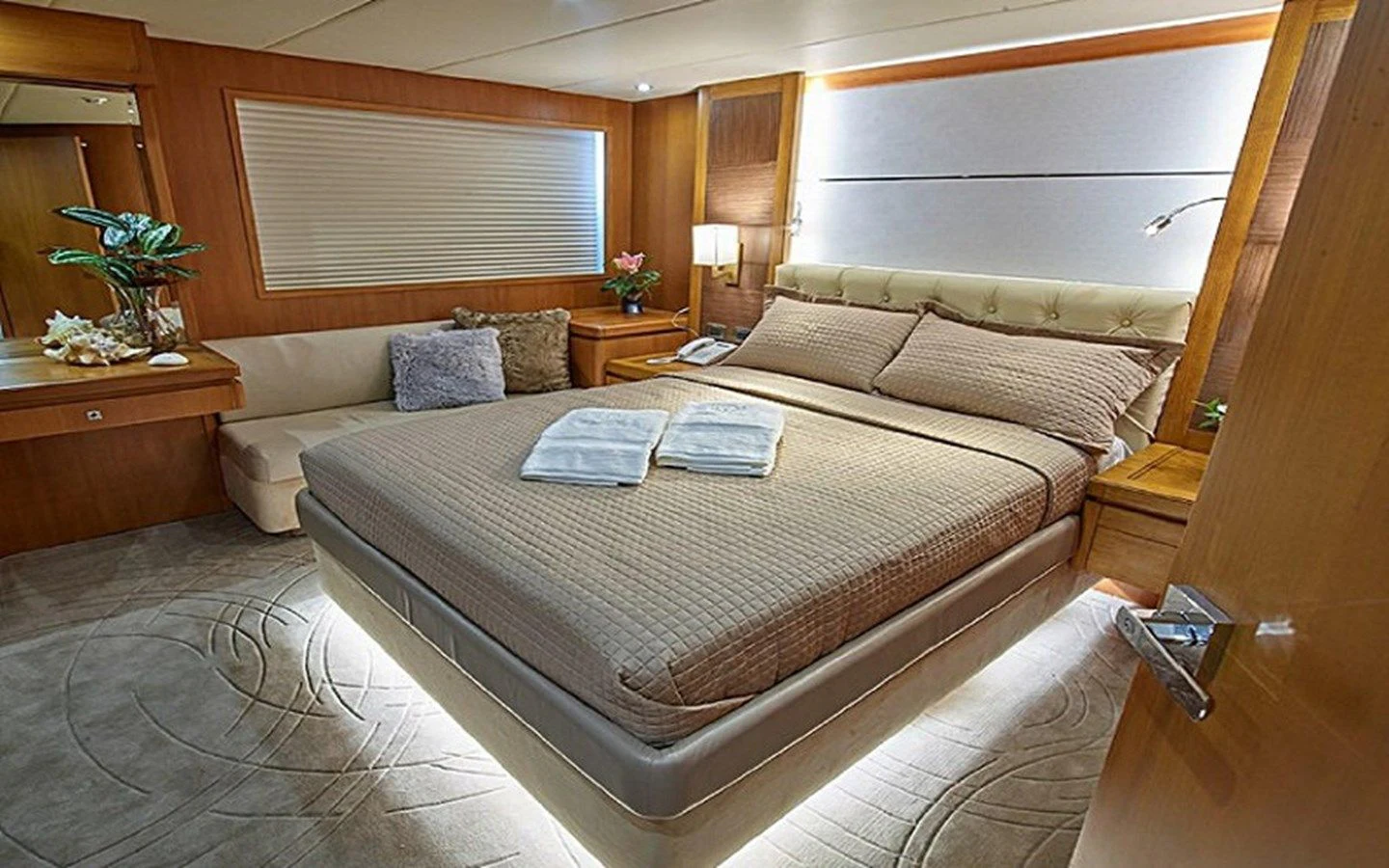 a bed with a white comforter aboard ALAIA Yacht for Sale