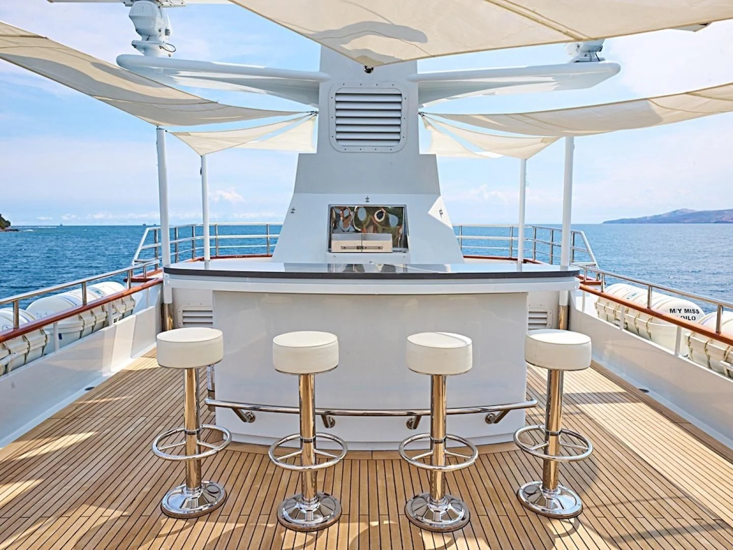 a boat with stools on a deck aboard ALAIA Yacht for Sale