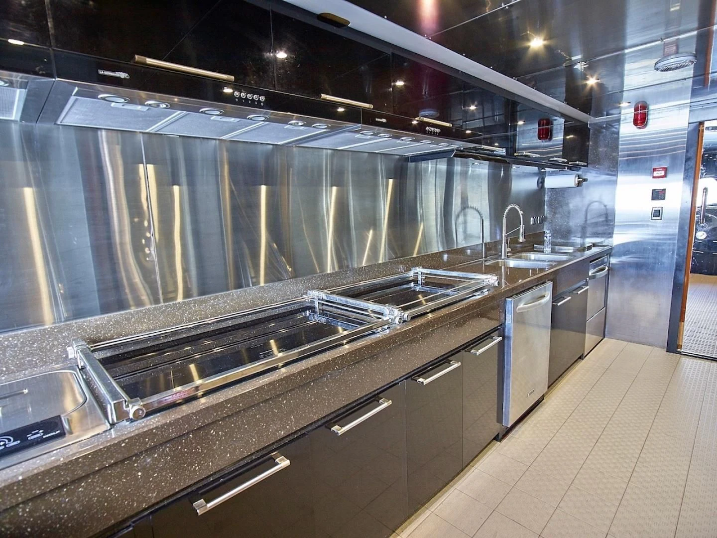 a large kitchen with stainless steel appliances aboard ALAIA Yacht for Sale
