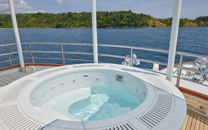 a large white boat on a body of water aboard ALAIA Yacht for Sale
