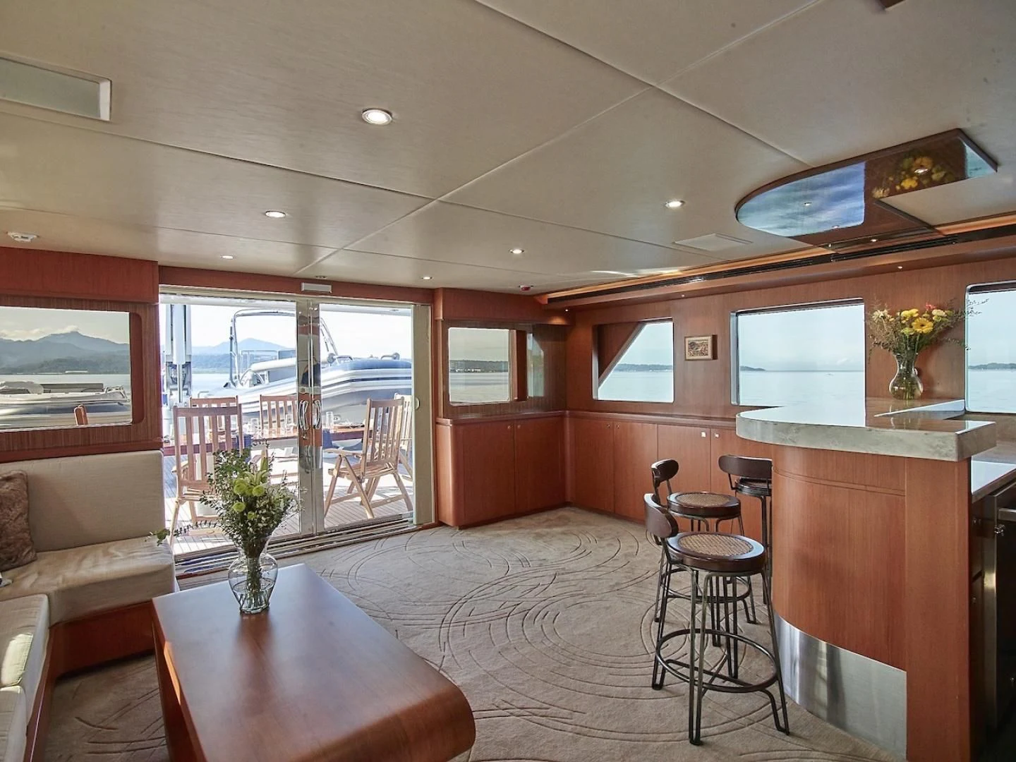 a living room with a table and chairs aboard ALAIA Yacht for Sale