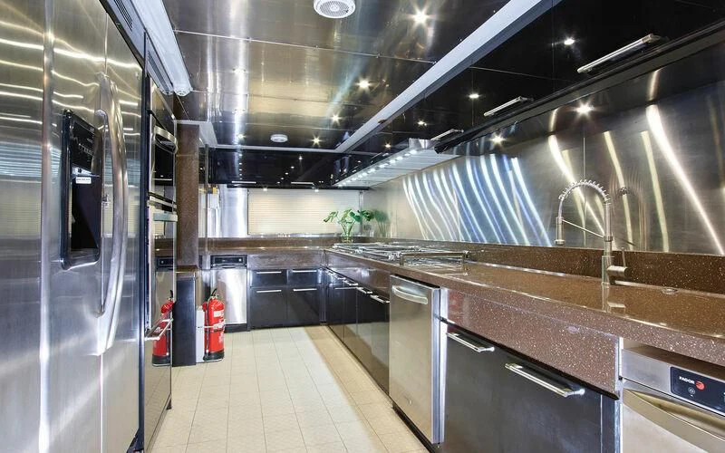a large kitchen with stainless steel appliances aboard ALAIA Yacht for Sale