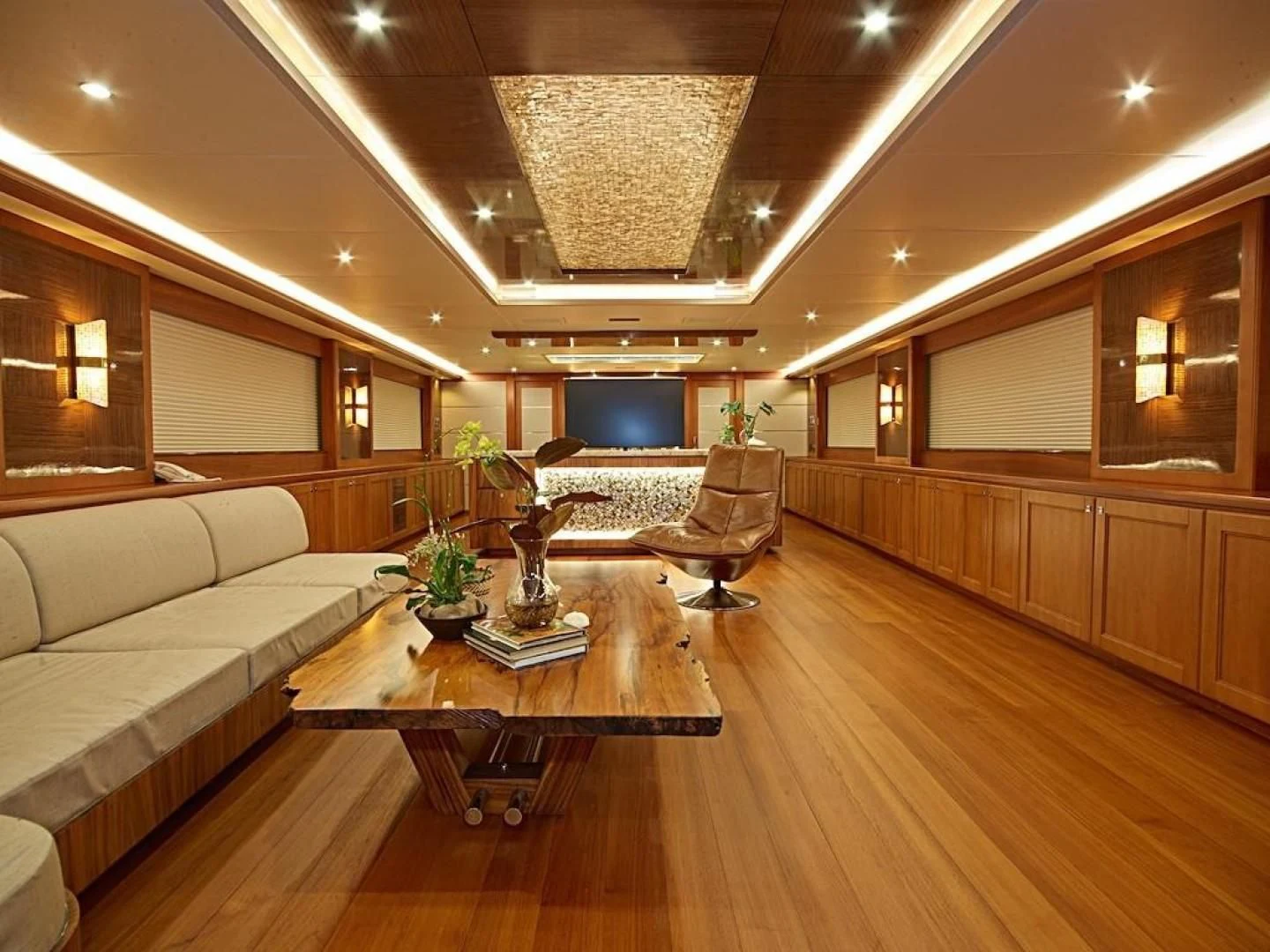 a living room with a couch and a coffee table aboard ALAIA Yacht for Sale