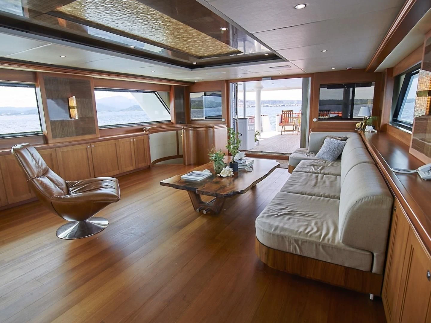 a living room with a wood floor aboard ALAIA Yacht for Sale