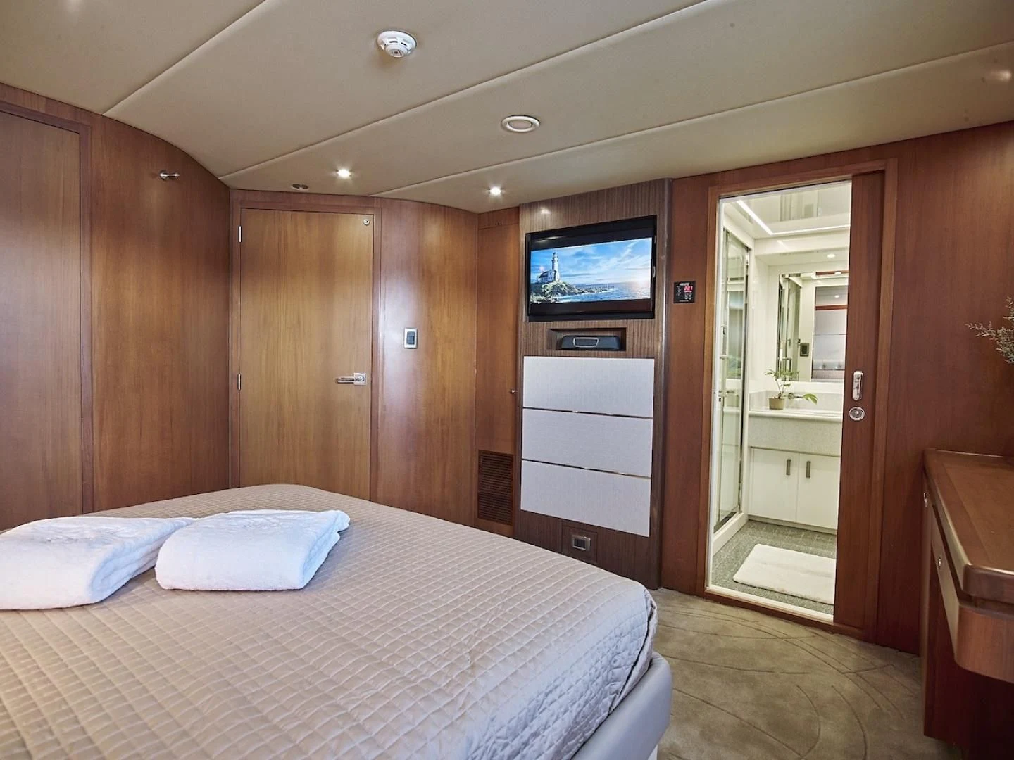 a bedroom with a bed and a television aboard ALAIA Yacht for Sale
