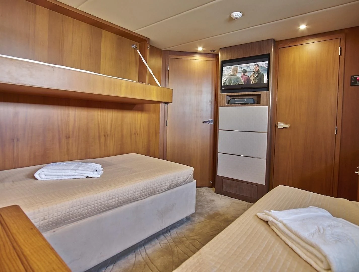 a bedroom with a bed and a television aboard ALAIA Yacht for Sale