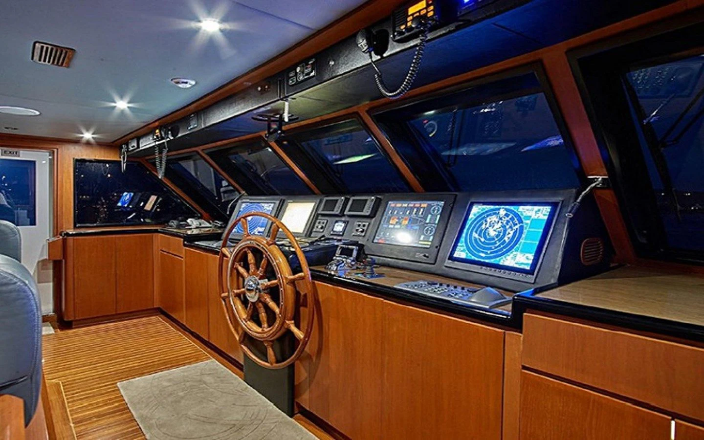 a room with a large tv and a wood cabinet aboard ALAIA Yacht for Sale