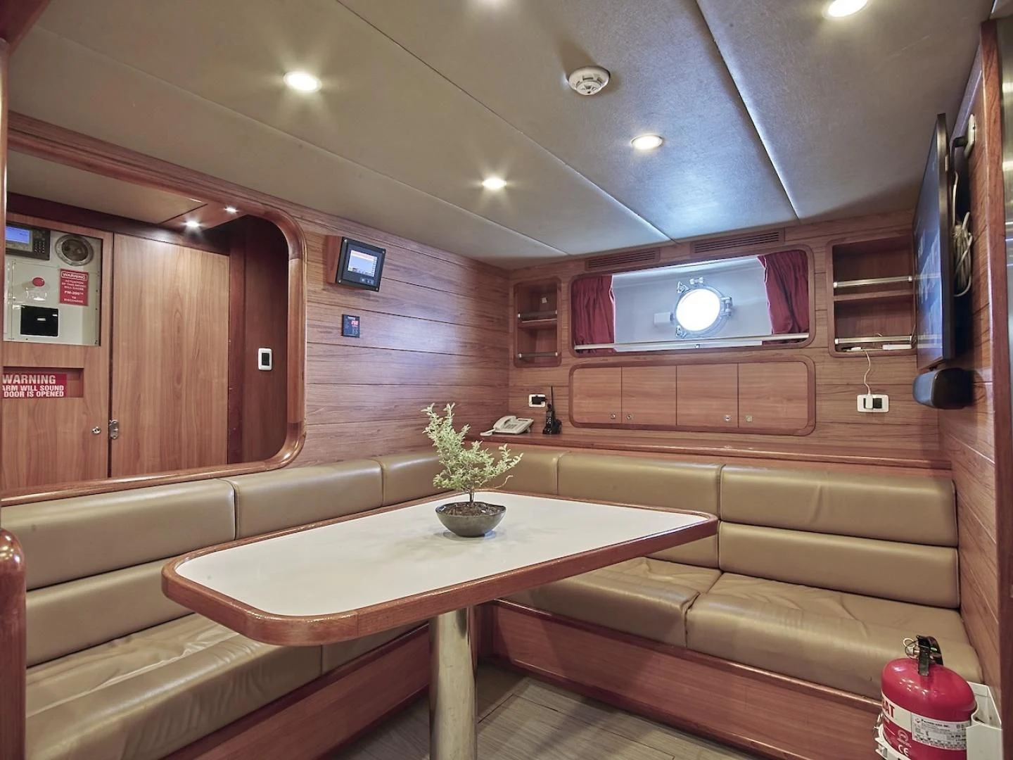 a room with a table and couch aboard ALAIA Yacht for Sale
