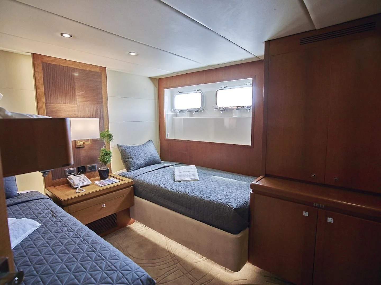 a bedroom with a bed and a desk aboard ALAIA Yacht for Sale