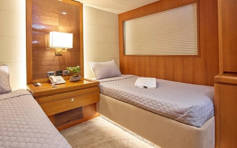 a hotel room with two beds aboard ALAIA Yacht for Sale