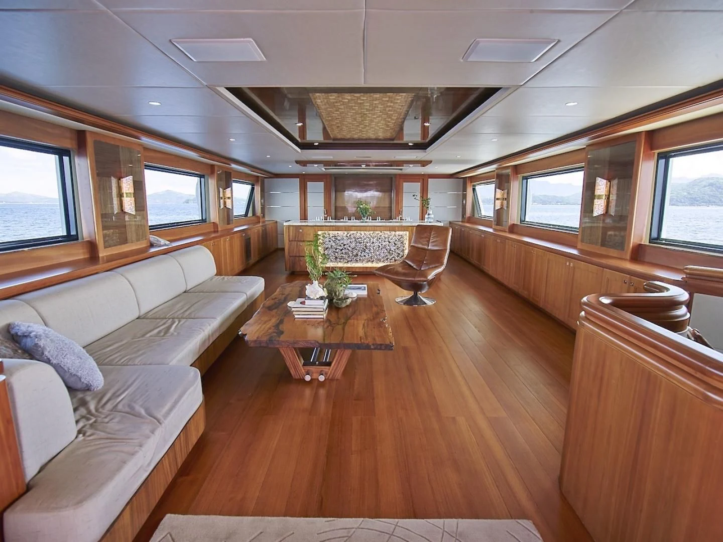 a living room with a wood floor aboard ALAIA Yacht for Sale