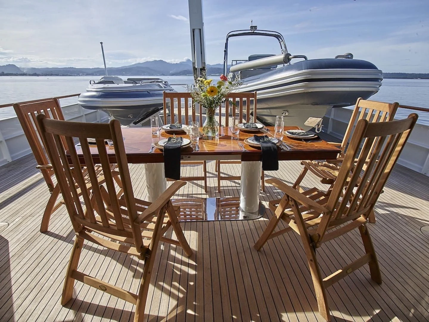a table with chairs on it aboard ALAIA Yacht for Sale