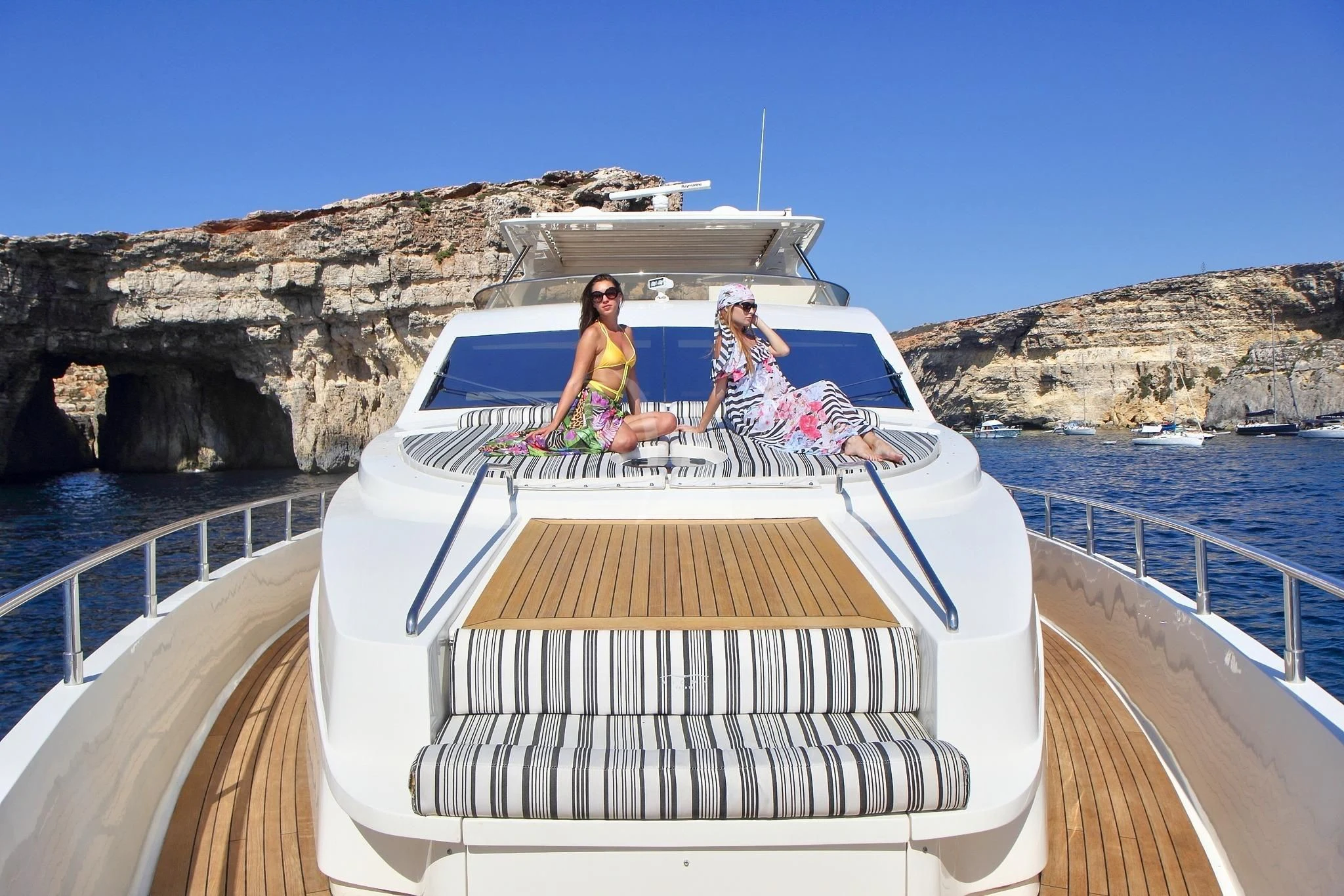 a group of people sitting on a boat on a body of water aboard SICILIA IV Yacht for Sale
