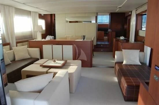 a room with a bed and a table aboard SICILIA IV Yacht for Sale