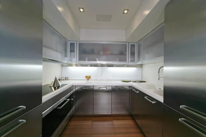 a kitchen with black appliances aboard SICILIA IV Yacht for Sale