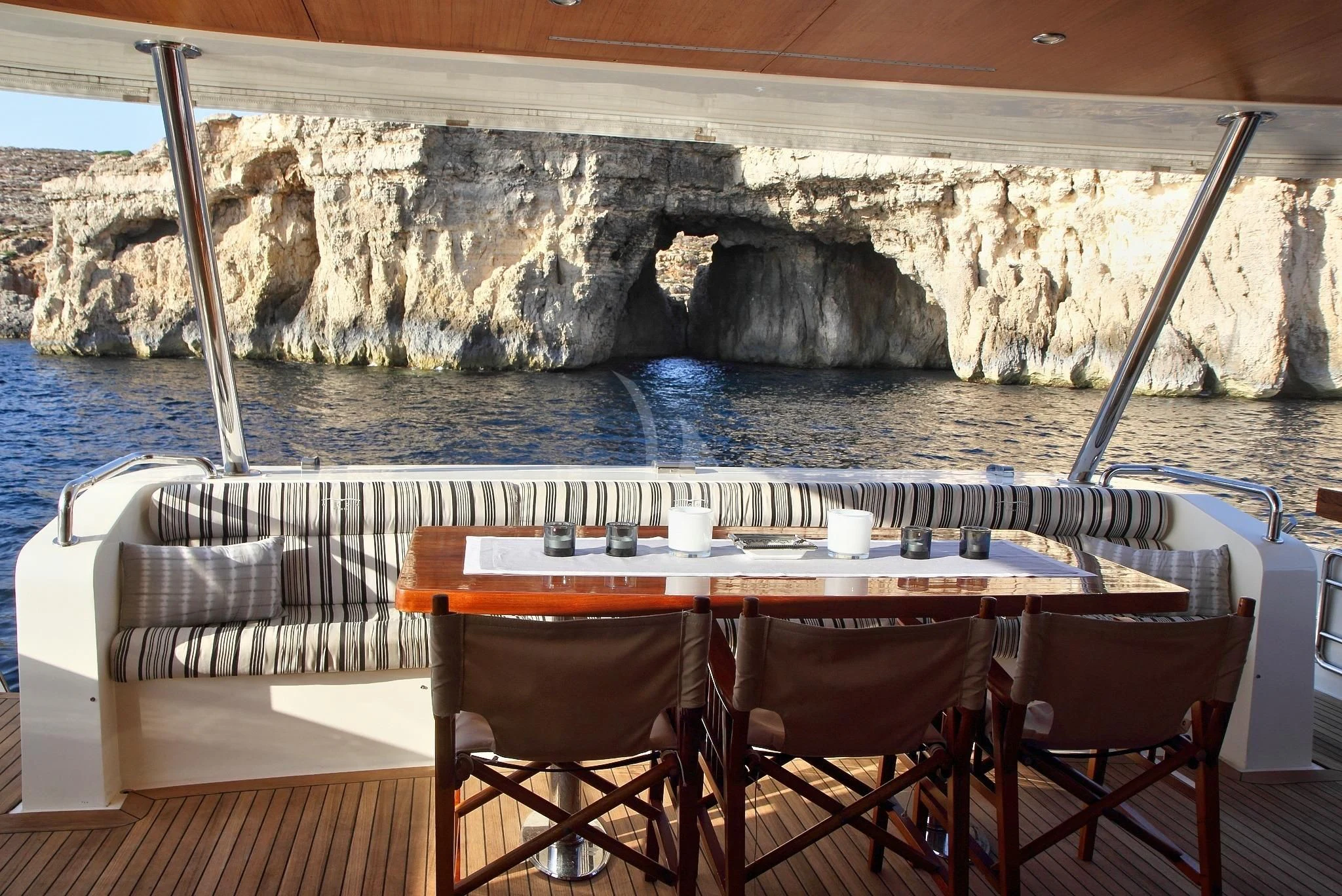 a table and chairs on a boat aboard SICILIA IV Yacht for Sale