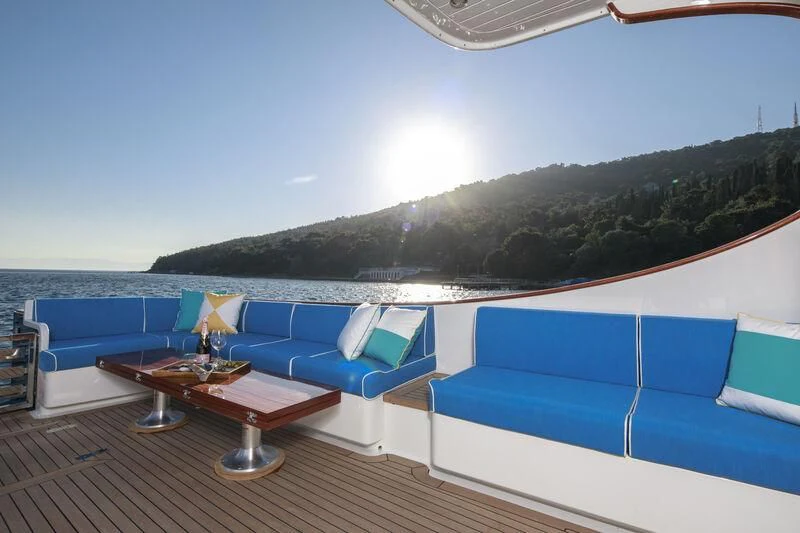 a pool with a table and chairs aboard ALECTO Yacht for Sale
