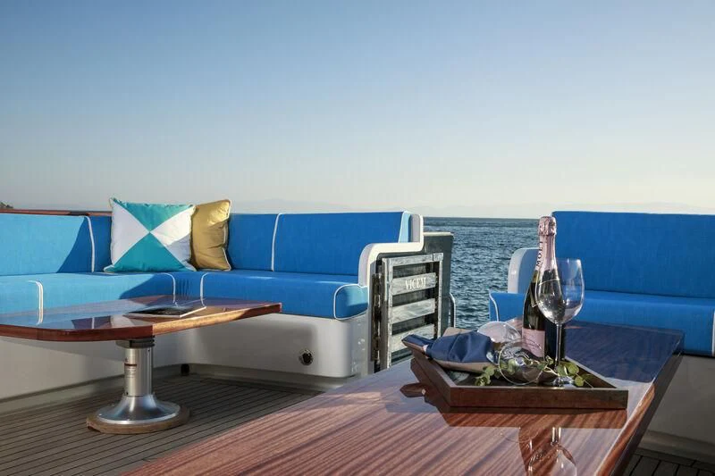 a table and chairs on a balcony aboard ALECTO Yacht for Sale