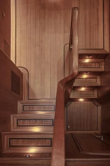 a set of stairs with a metal railing aboard ALECTO Yacht for Sale