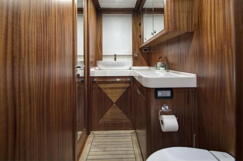 a bathroom with wooden cabinets aboard ALECTO Yacht for Sale