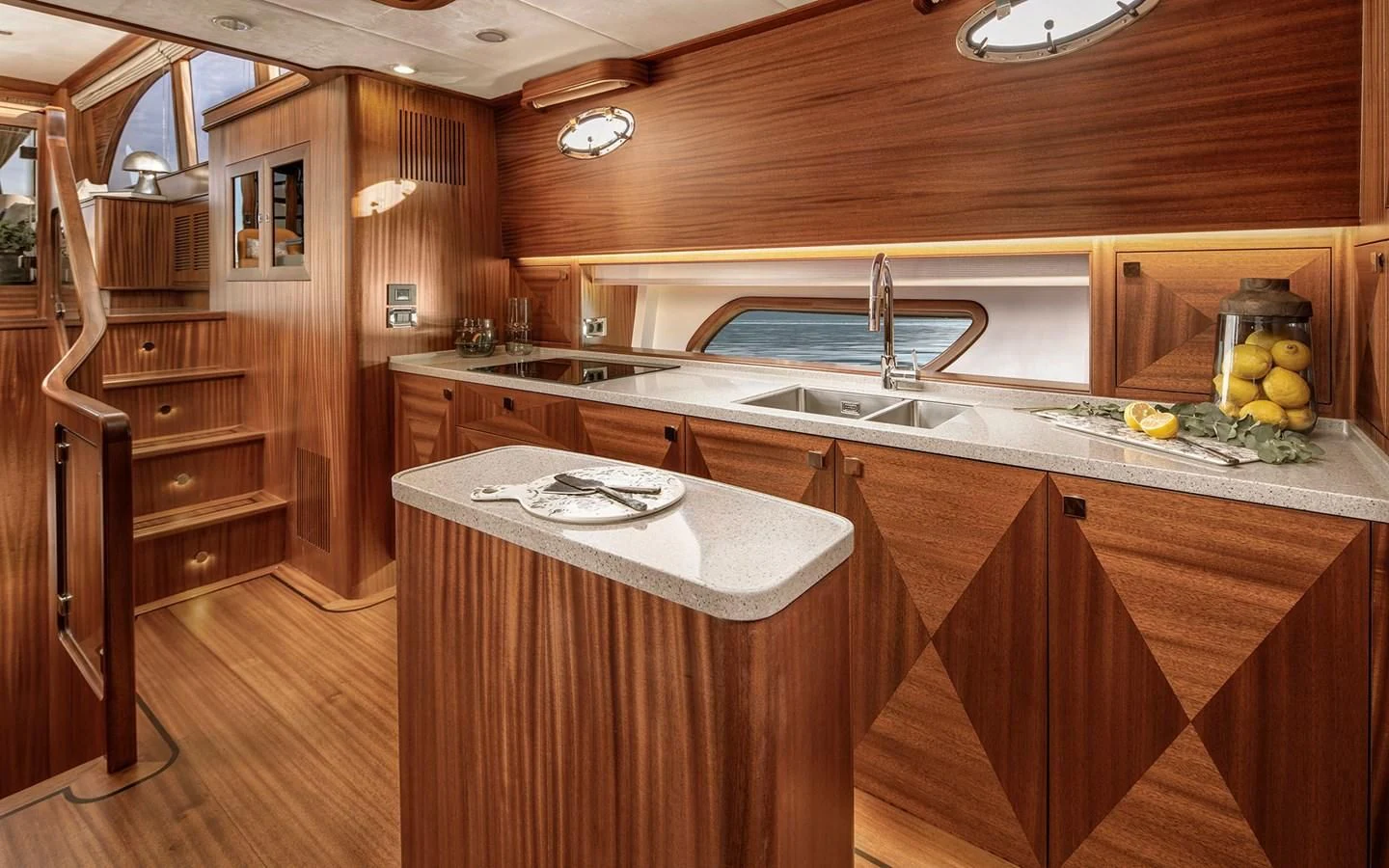 a kitchen with wooden cabinets aboard ALECTO Yacht for Sale